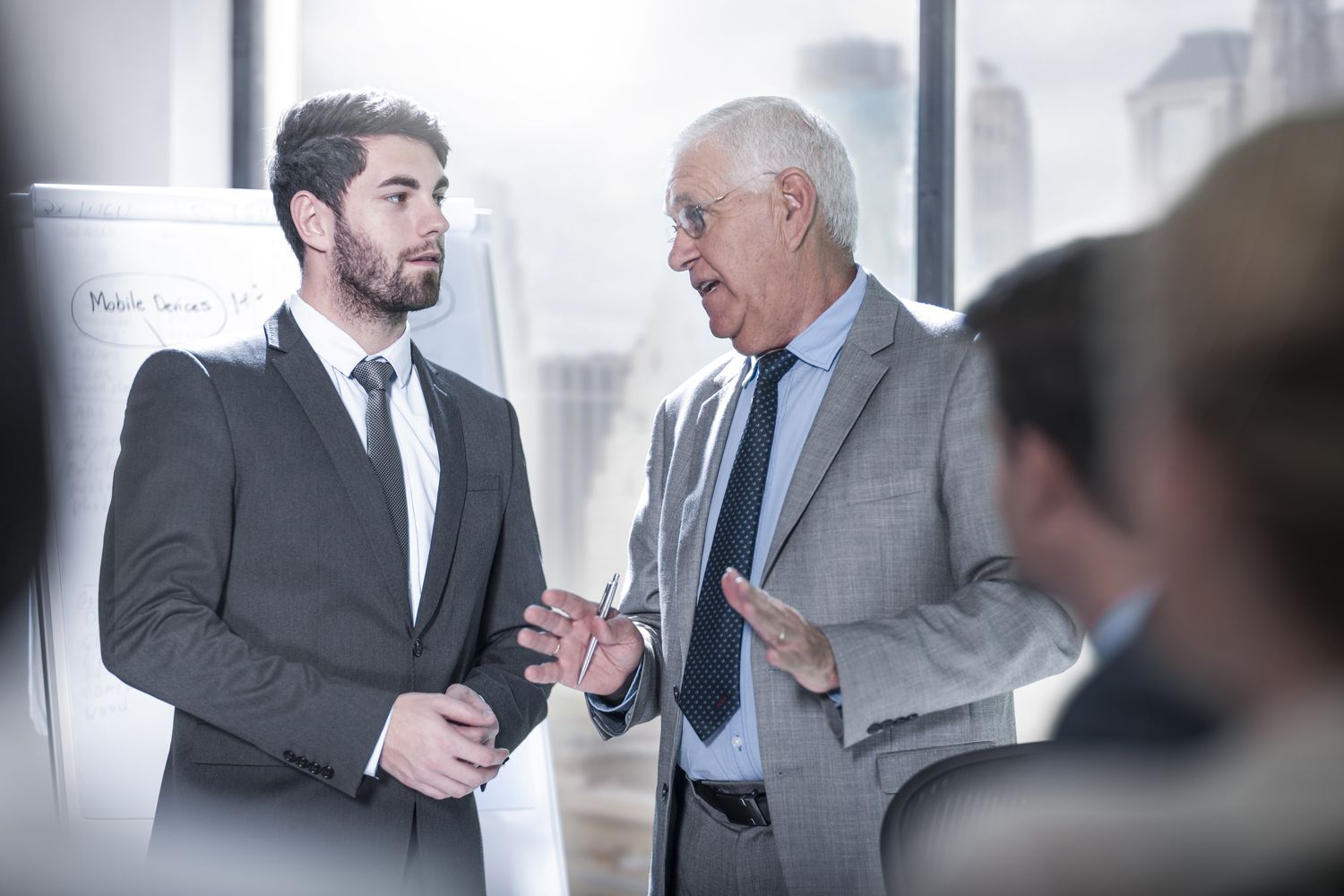 two-businessmen-talking-in-city-office-726794195-5b54c57946e0fb005b66d698