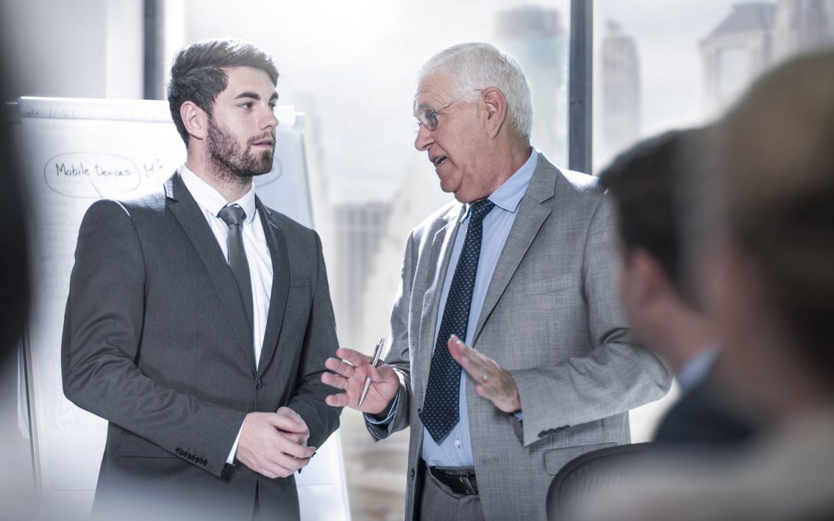 two-businessmen-talking-in-city-office-726794195-5b54c57946e0fb005b66d698